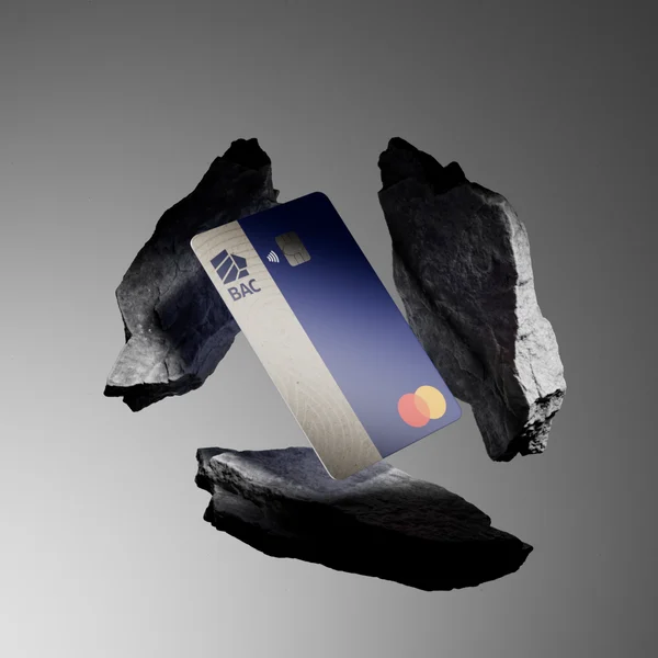 CGI visualization of a BAC credit card surrounded by dark rocks